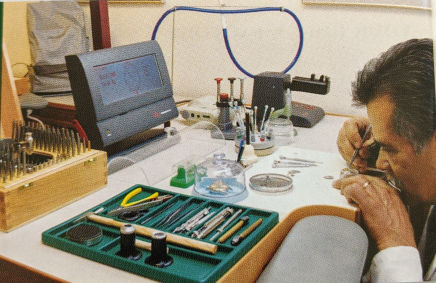 Rolex watchmaker working at a bench 